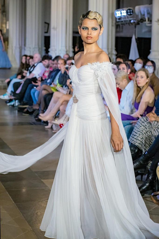 Elegant White Off-Shoulder Gown with Chiffon Drape and Modern Cut-Out Detail