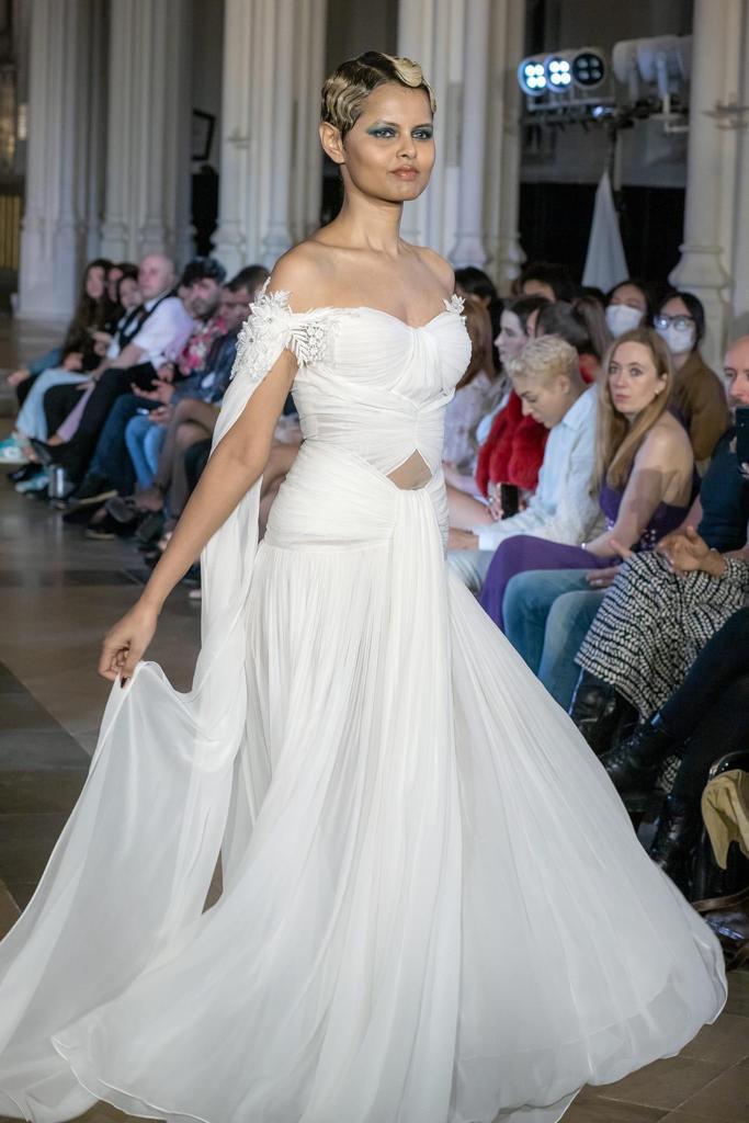 Elegant White Off-Shoulder Gown with Chiffon Drape and Modern Cut-Out Detail