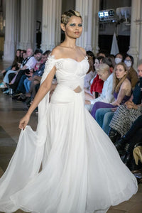 Elegant White Off-Shoulder Gown with Chiffon Drape and Modern Cut-Out Detail