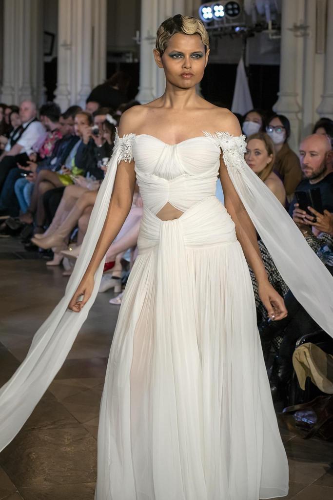 Elegant White Off-Shoulder Gown with Chiffon Drape and Modern Cut-Out Detail