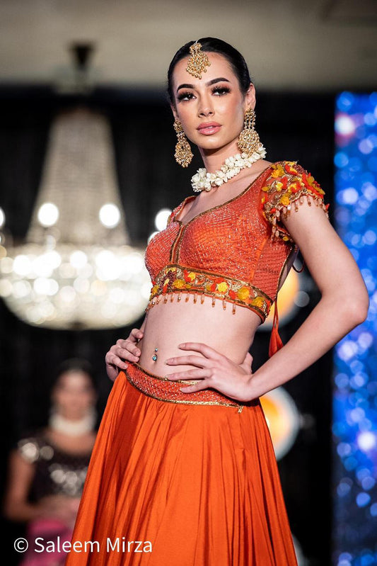 Vibrant Orange Silk Lehenga Choli Set with Detailed Embroidery